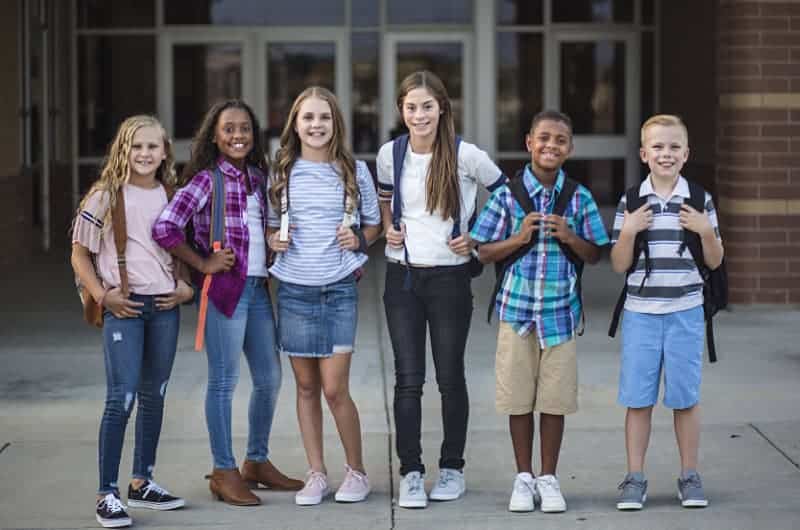 Tom Aylesworth Legacy Fund students standing in front of school